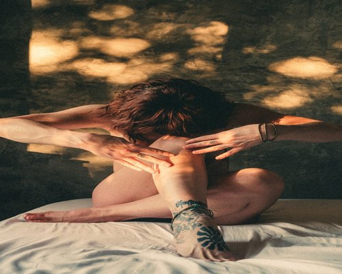 man stretching arms in morning light